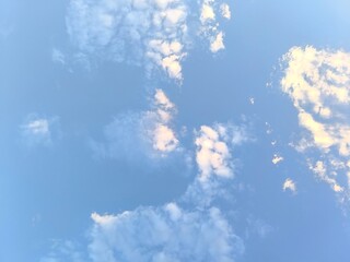 Wispy white clouds drift across bright blue sky for peaceful natural atmosphere design. © Fight Studio