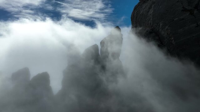 Aerial view of Punta Carina rock formations in the clouds, Italy.
