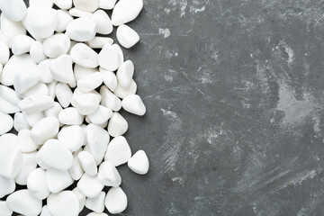 White pebble stones on concrete background, top view © Liami