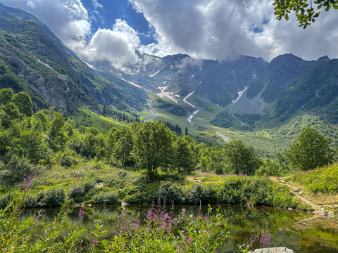 Alpine valley with lake and flowers in Les Contamines-Montjoie, France