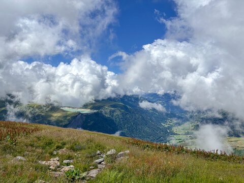 Cloudy alpine valley view from mountain meadow in Les Contamines-Montjoie, France