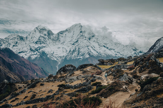 Snowy Himalayan peaks above a rugged mountain trail in Nepal