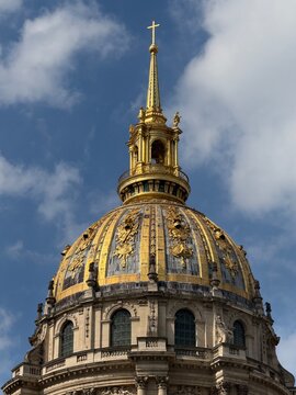 Golden dome of Les Invalides in Paris against blue sky