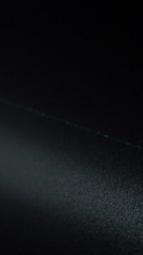 Powerful flashlight shines into night sky during Russian drone attack. Bright beam lights area above peaceful civilian city. Vigilance during Russian aggression war