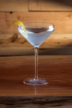The classic Vesper Martini, served in a modern coupe glass on a wooden background.