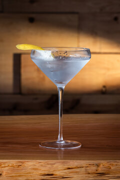 The classic Vesper Martini, served in a modern coupe glass on a wooden background.
