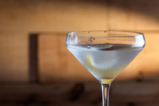 The classic Vesper Martini, served in a modern coupe glass on a wooden background.