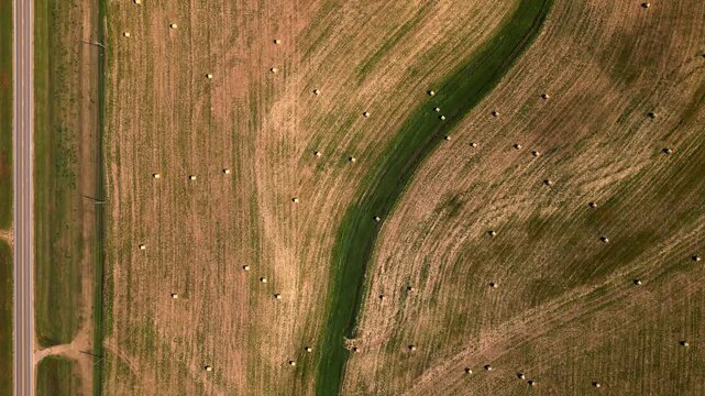 Top down aerial pattern of a mown hay field and grass waterway