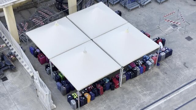 28 April 2026 Italy, Sicily, Messina, Cruise Ship Terminal - embarkation and debarkation day of passenger luggage placed under tents at port to pick up