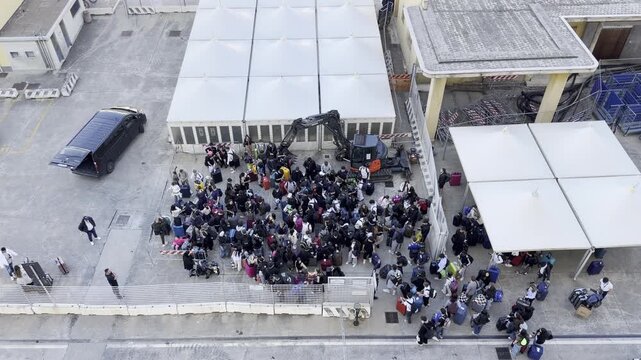 28 April 2026 Italy, Sicily, Messina, Cruise Ship Terminal - turnaround day of passenger group disembarking and picking up luggage
