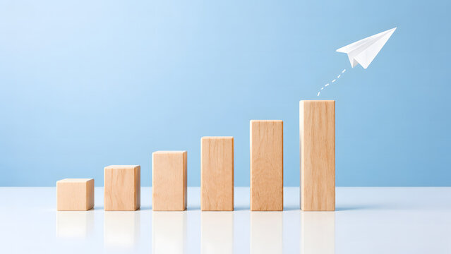 A white paper airplane launches upward from rising wooden bar chart blocks against a blue background. The ascending steps symbolize career progress and business startup growth. Vector concept.