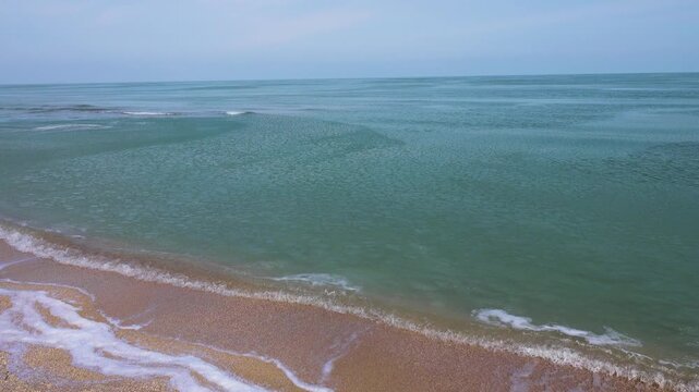 Cream ice, ice fat on Azov Sea. In calm, frosty weather, even salt water freezes, pancake ice forms, and when pores filled, ice crystals merge into flexible mass that extinguishes waves. Foam hardens