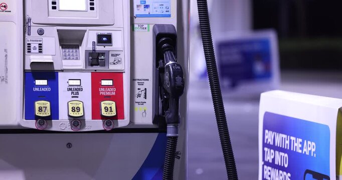 Fullerton, California, USA - September 14, 2026: Vehicles refuel at a gas station with prices surging due to the ongoing war with Iran. 