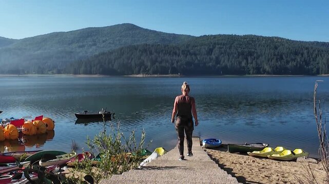 Traveller walking by the beautiful Lago Arvo in the Sila mountains