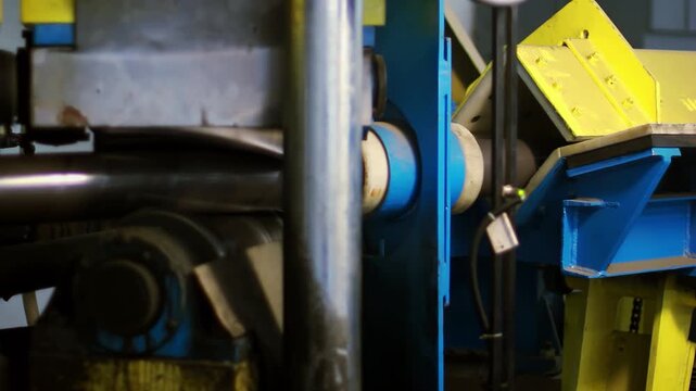 Pipe bending machine rollers close up. Heavy equipment metalworking plant shop.