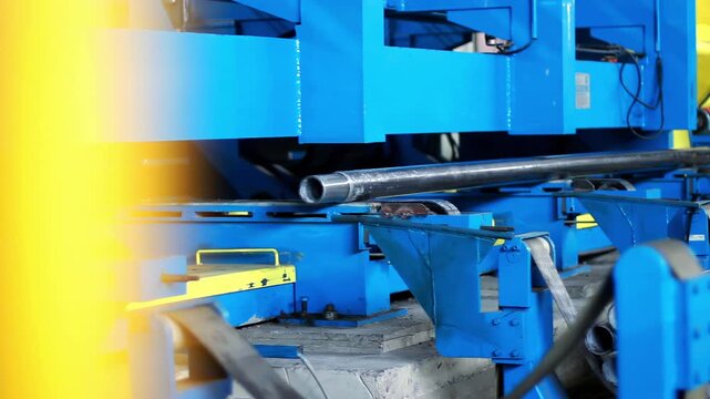Industrial pipe cutting machine sorting steel tube conveyor. Metalwork plant.