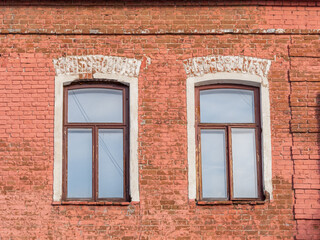 Two windows of the old mansion 19 century with brown bricks wall © Dmitrii Potashkin