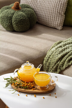 Warm Sea Buckthorn Tea Served in Glass Pot and Cup with Fresh Berries on Tray Cozy Autumn Home Ambiance