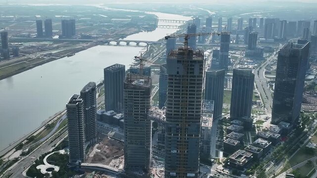 Aerial view of modern city construction with skyscrapers and river