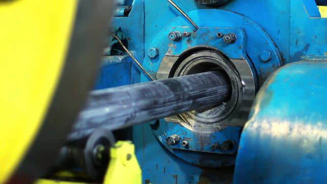 Closeup steel pipe rotating lathe machine. Metalworking factory production line.