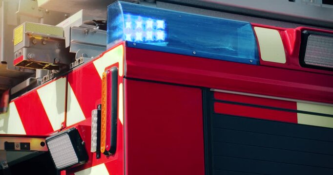 Fire truck emergency service vehicle with flashing lights. Red fire engine with ladders, firefighting apparatus and water to save lives, extinguish fires and assist vehicle collision.