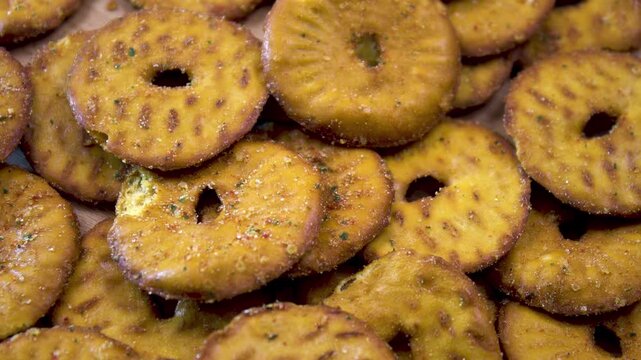 Ring shaped savory snack chips with seasoning, macro close-up