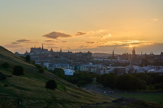 Edinburgh skyline at sunset from Holyrood Park with warm golden light