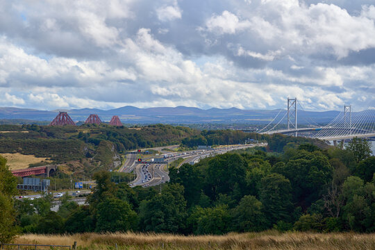 Forth Bridges spanning the Firth of Forth near South Queensferry on a cloudy day