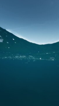 Split level view of deep blue sea and clear sky