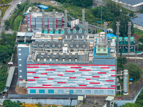 Aerial view of Nxtra Data Centre featuring a large industrial building with a red and grey patterned facade, cooling towers, and surrounding greenery in Hinjawadi, Maharashtra, India.