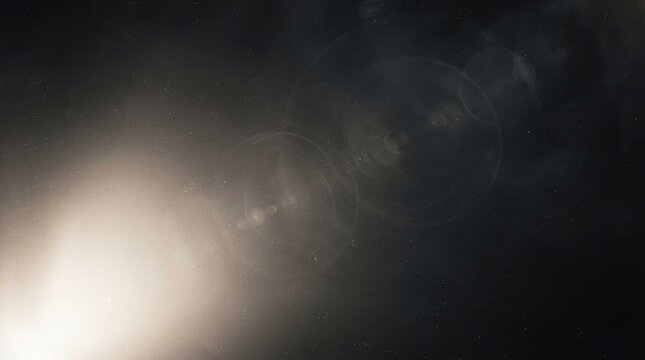 Abstract dark background with bright light flare and lens effect