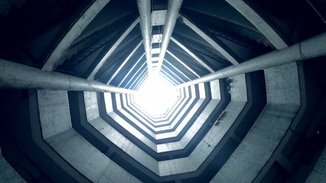 Looking Up Inside Modern Concrete Silo Tower With Bright Light And Industrial Pipes