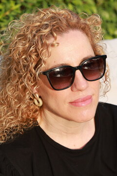 Smiling Woman Enjoying a Sunny Summer Day by the Pool