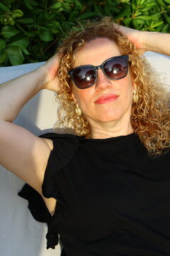 Smiling Woman Enjoying a Sunny Summer Day by the Pool