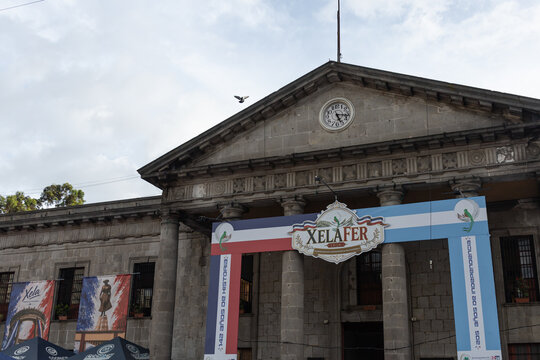 Quetzaltenango, GUATEMALA - Sep 13 2026 : XelaFer 2026 archway and Xela banners below the pediment of the Natural History Museum. Translation : 142 Years of History, 205 Years of Independence