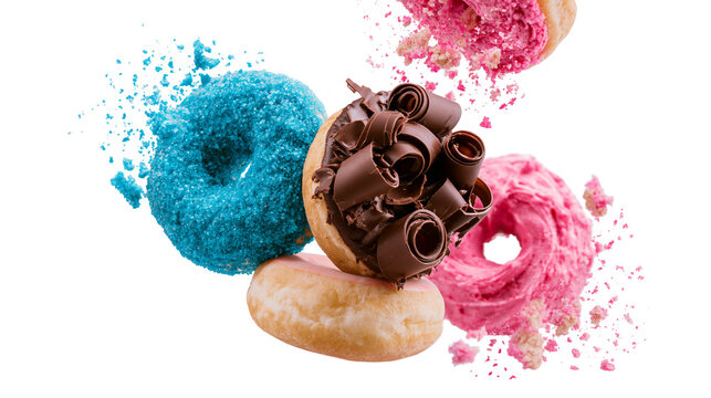 Isolated delicious flying donuts with colorful frosting, chocolate curls, and exploding crumbs