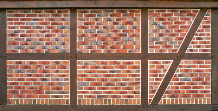 Fachwerk - braune Balken gef&uuml;llt mit rot gemusterten Backsteinen und wei&szlig;en M&ouml;rtelfugen