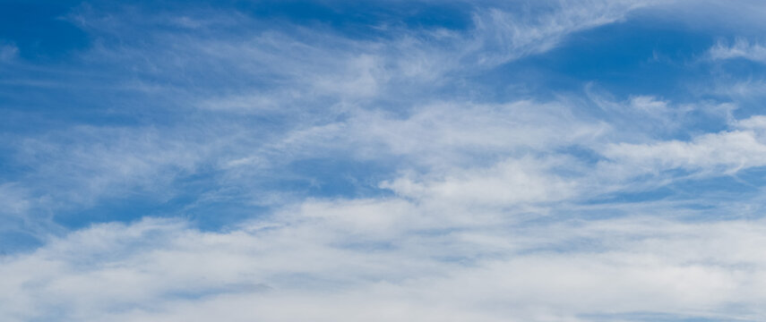 Blue sky with light wispy clouds in daytime