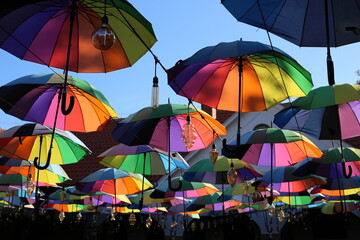 many different umbrellas under the blue sunny sky © Maryna