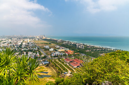 A view down the coastline landscape from the Marble Mountains in Da Nang, Vietnam on a bright sunny day