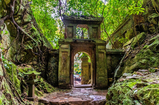 A view towards a gateway on an upper level of the Marble Mountains in Da Nang, Vietnam on a bright sunny day