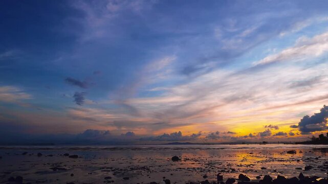 Dramatic Sunset Sky Over Rocky Tidal Flats at Low Tide