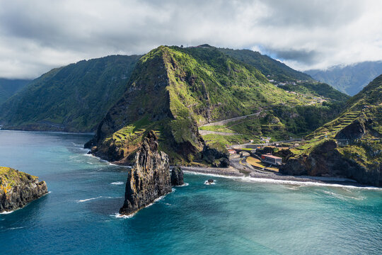 Aerial coastal landscape of Ribeira da Janela canyon and terraced green mountains, Madeira, Portugal