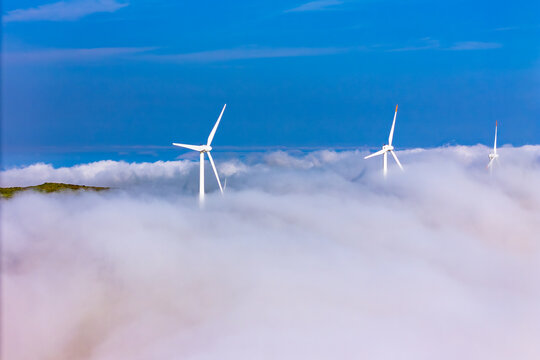 Wind turbines in clouds above Madeira Island. Renewable electricity production in isolated island energy system