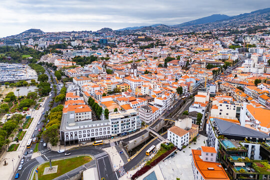 Aerial view of urban cityscape with red tile roofs in historic center of Funchal, Madeira, Portugal.