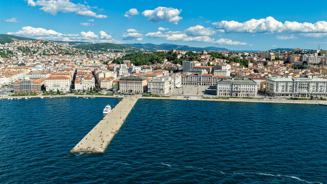 Aerial view of Piazza Unita d'Italia and the Molo Audace pier extending into the Adriatic Sea, surrounded by historic architecture and urban waterfront in Trieste, Friuli-Venezia Giulia, Italy.