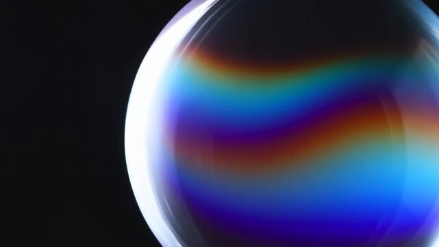 Glowing rainbow sphere with colorful light gradient against a black background