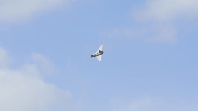 Military fighter jet performing spectacular aerobatic maneuver