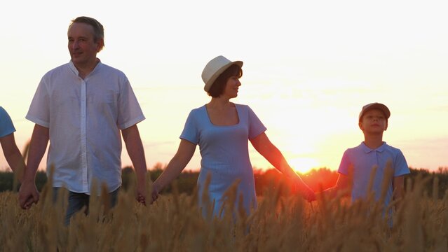 happy family, parents man woman holding children hands sunset park, mother father parents kid outdoors nature, family camping under stars, agronomist grow growing, warm light, simple joys of summer in