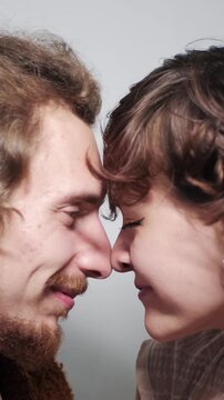 Couple touching noses with eyes closed, sharing love, affection and trust in romantic moment of emotional intimacy and connection. Vertical video. 
